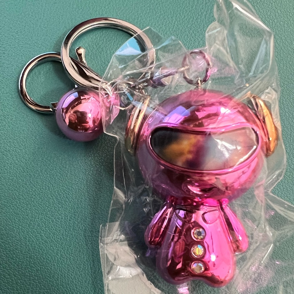 A chrome pink astronaut keychain